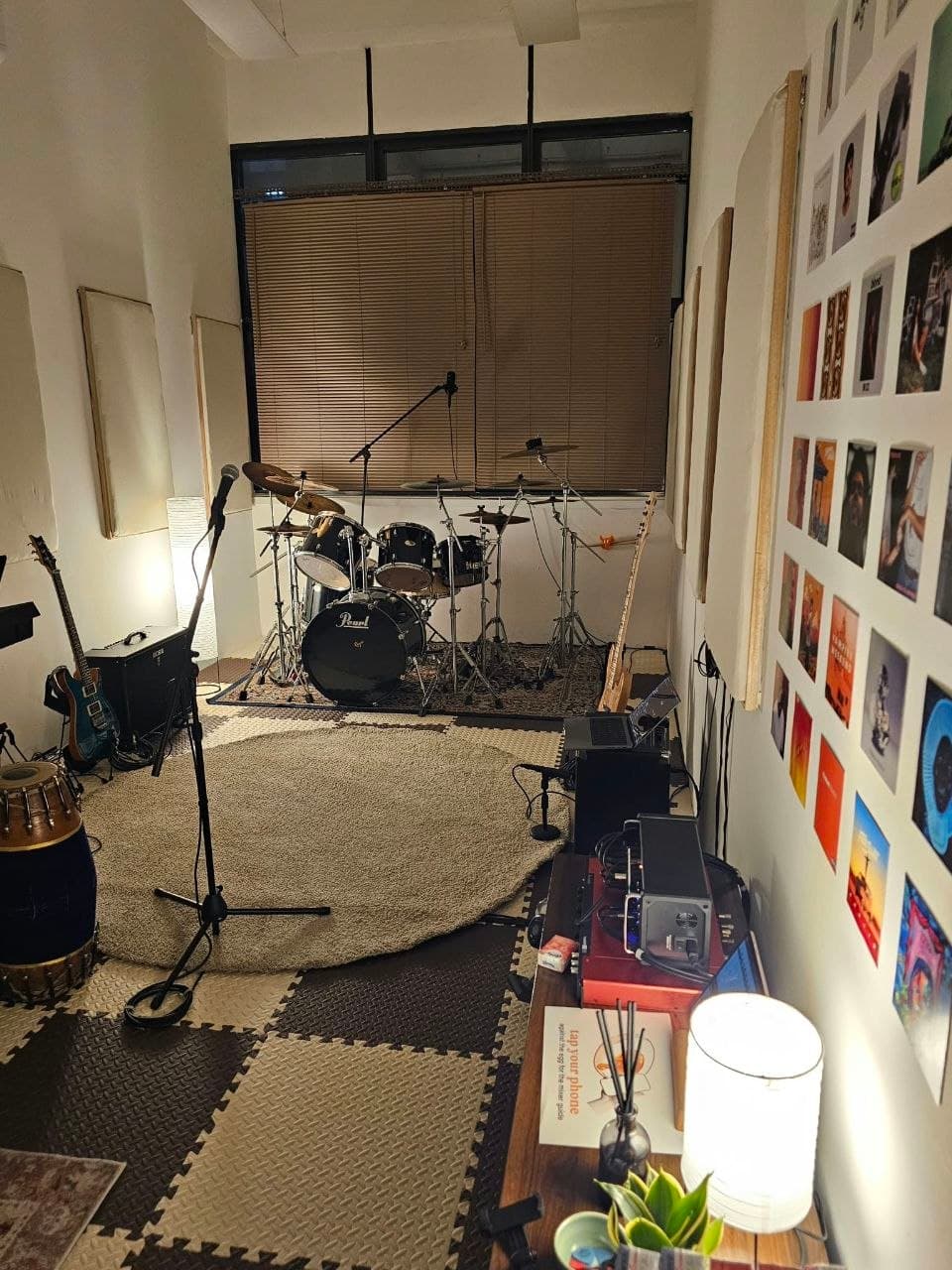 Rehearsal room set up with instruments and a drum kit